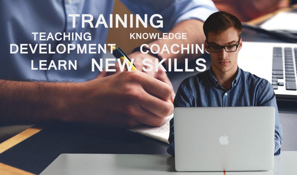 This image contains a person working on their laptop, with the following words: Training, teaching, knowledge, teaching, development, coaching, learn, new skills.